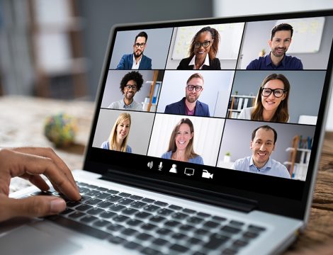 Man Working From Home Having Online Group Videoconference On Laptop